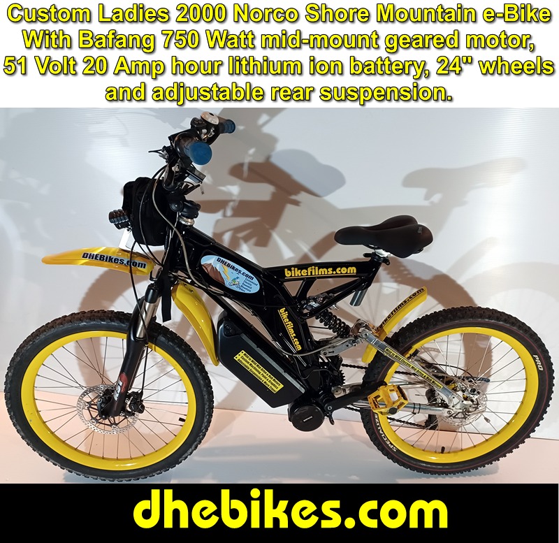 Custom made to order Womens electric downhill mountain bike by Pinnacle Innovations cockpit view showing the GripShift shifters, high rise bar and the Bafang 750 Watt mid mount electric motor throttle.
